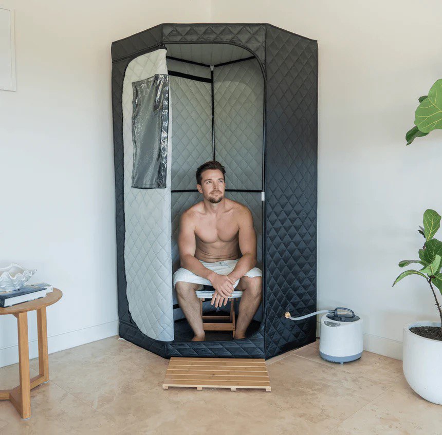 Man enjoying the benefits of AuraPro sauna, relaxing in a comfortable and efficient steam therapy session.