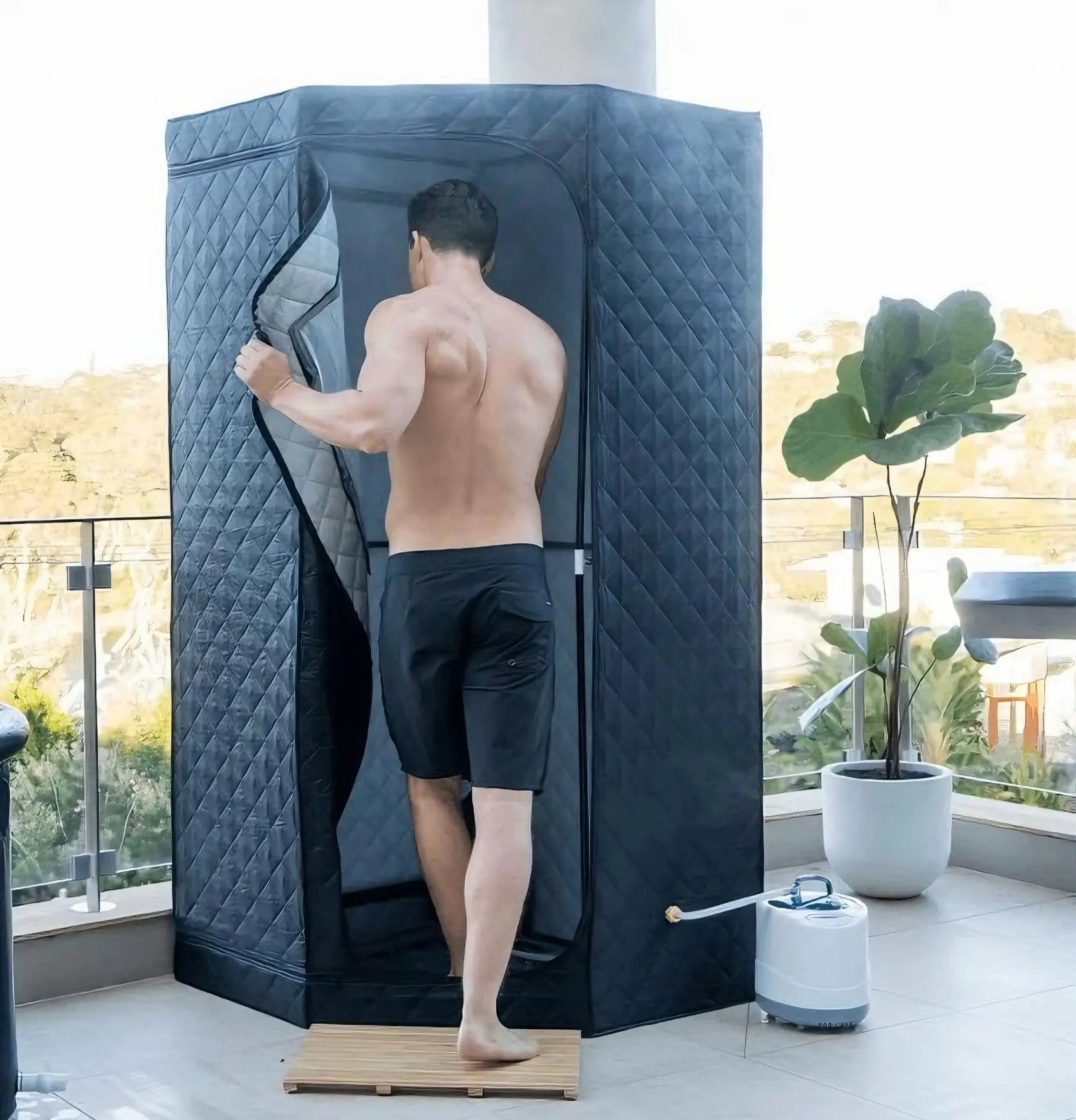 MAN RELAXING IN STEAM SAUNA IN THE BALCONY